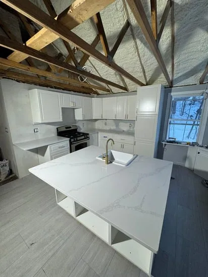 Installation of Calacatta Milano Barrington NH quartz on kitchen countertops.