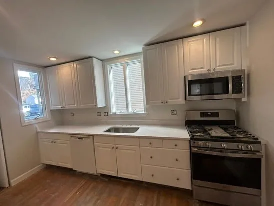 Full perspective of a residential kitchen remodel utilizing Calacatta Milano South Boston for all countertop areas.