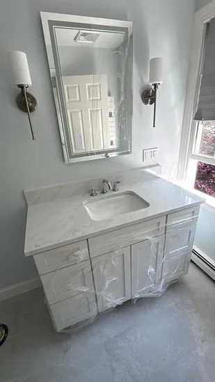 Side view of an Imperiali Grey Quartz Acton project featuring a custom countertop and integrated sink.